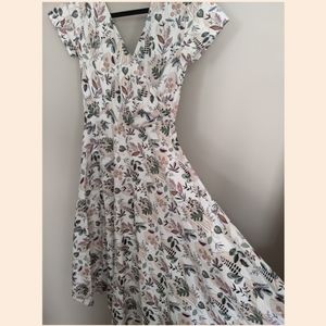 Faux wrap swing dress in leaf and flower print